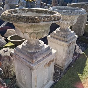 Pair of Vintage urns on plinths