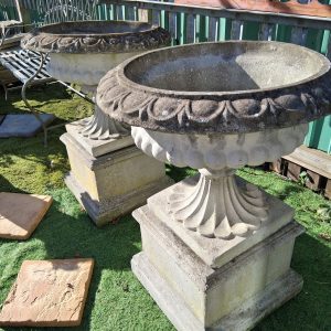Pair of large weathered  Vintage Urns on plinths